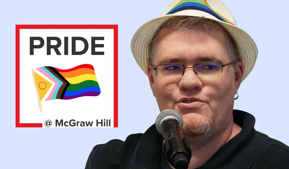 Denni speaking with the Pride at McGraw Hill logo behind him