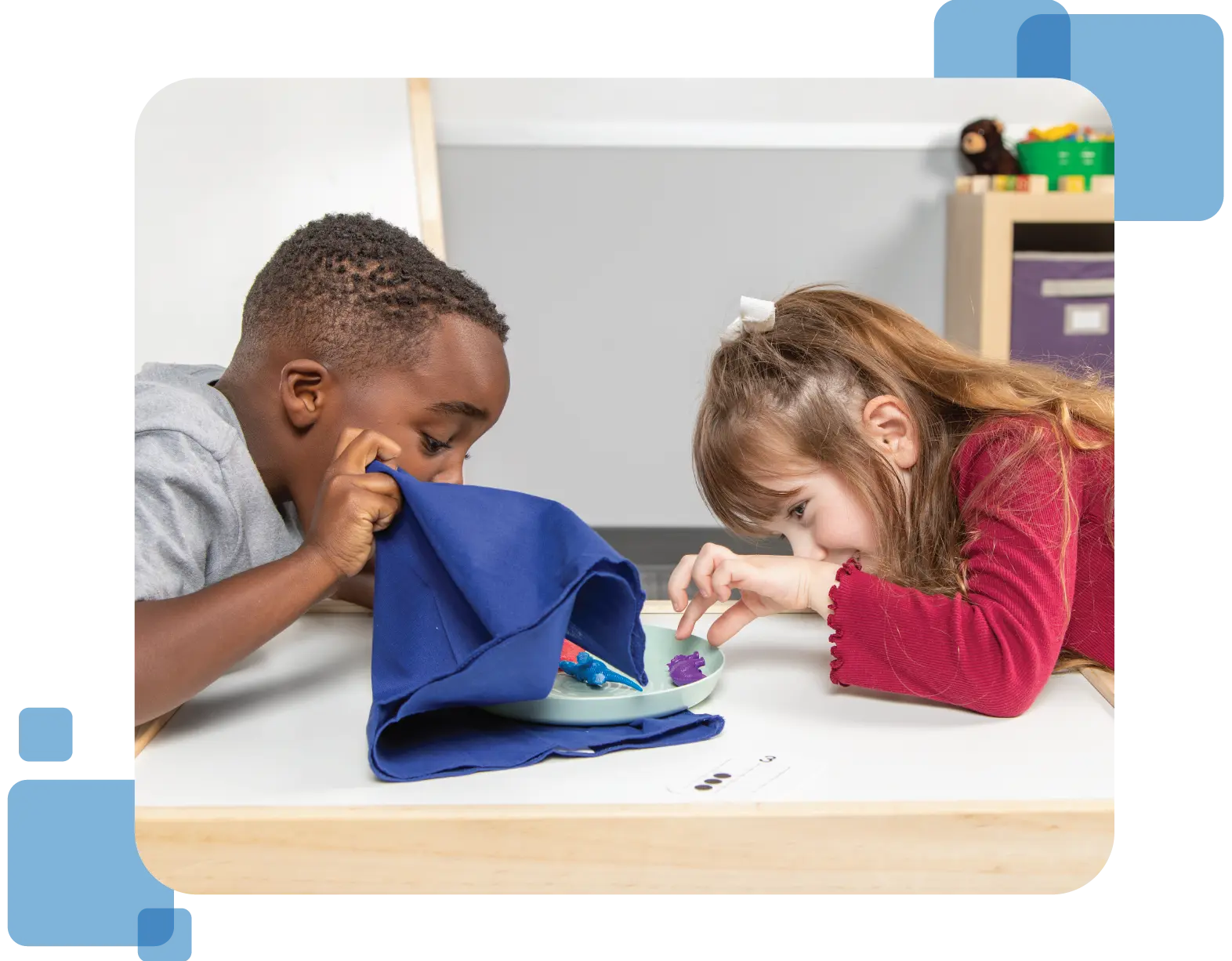 Two preschoolers excitedly investigate Dino Counter program manipulatives.