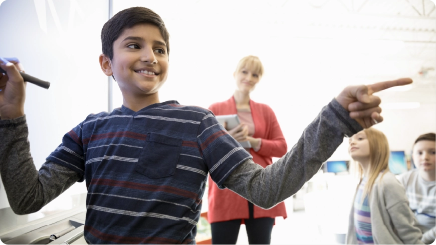 A student solves problem in front of class
